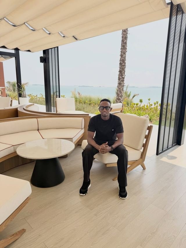 Nasir Hassan seated on a terrace overlooking the sea in Dubai